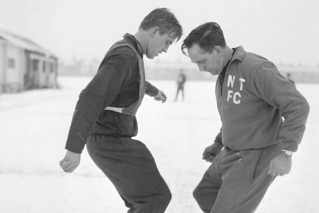 Dave Bowen (right) goes through a training routine with Graham Moore