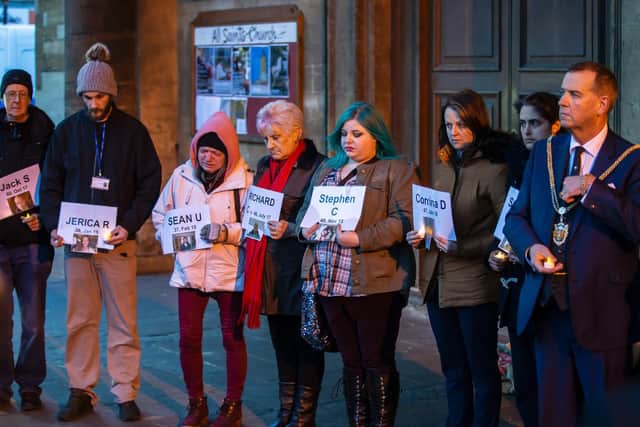 Signs to remember each one of the homeless community who have died since July 2017 were held up by members of the public.