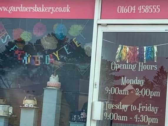 The banner in the shop window of Gardners Bakery in Kingsthorpe has caused offence.