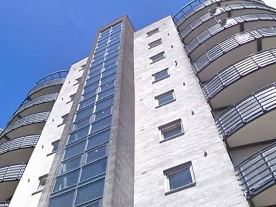 An investigation has been launched after rocks were thrown from the roof of the flats in Woolmonger Street on Saturday.