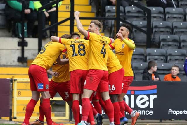 TURNAROUND! Cobblers celebrate after Sam Hoskins' deflected free-kick puts them 2-1 ahead at Meadow Lane.