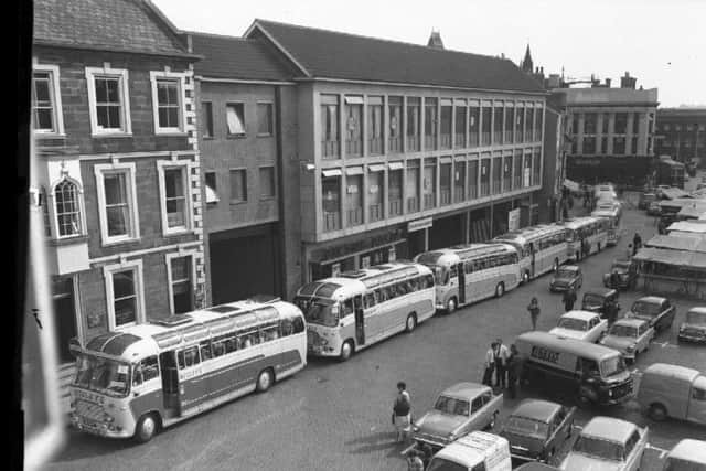 Coaches gather on Northampton Market Square outside the Peacock Way arcade on September 10, 1964