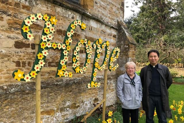 Ceila Irwin pictured with reverend Byung June Kim, stood next to her display at St Peter & St Paul's Church in Park Avenue South.