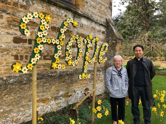 Ceila Irwin pictured with reverend Byung June Kim, stood next to her display at St Peter & St Paul's Church in Park Avenue South.