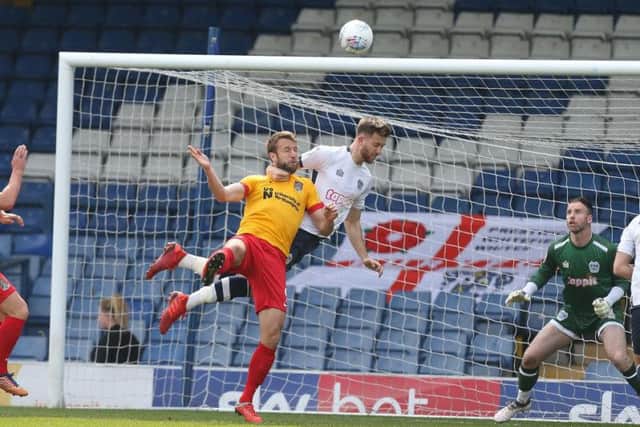 Andy Williams challenges for the ball. Pictures: Pete Norton