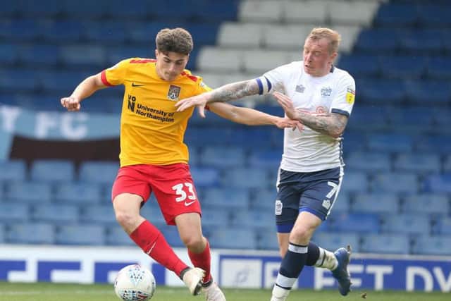 Scott Pollock tussles with former Cobblers man Nicky Adams. Pictures: Pete Norton
