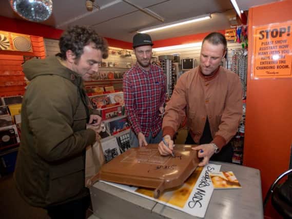 Sleaford Mods pictured signing a fan's bin lid.
