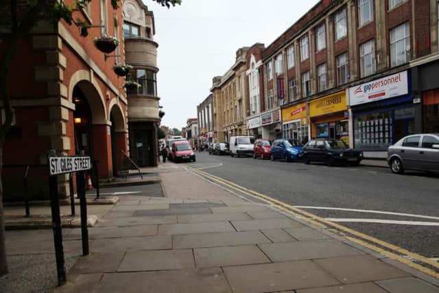 A man has been arrested after a business on St Giles Street was broken into on Thursday morning.