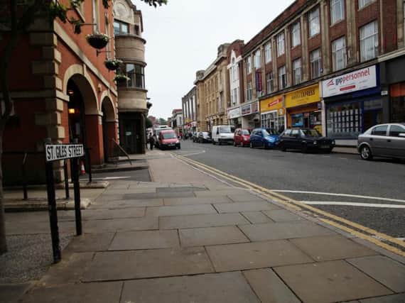 A man has been arrested after a business on St Giles Street was broken into on Thursday morning.