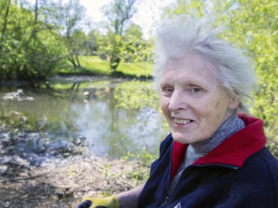 Bridget Owens pictured next to Kingfisher Lake which she has spent weeks clearing up alone.
