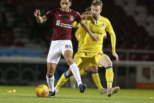 Chris Lines battles with Cobblers defender Jay Williams during Bristol Rovers' Checkatrade Trophy win at the PTS Academy Stadium in January