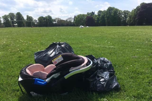 A car seat has been left behind amongst the rubbish in Dallington Park today.