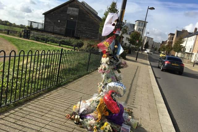 Flowers left at the scene of the shooting in October 2018.