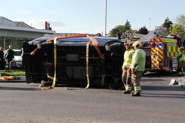 An overturned van outside of Wollaston Motors is causing major delays.