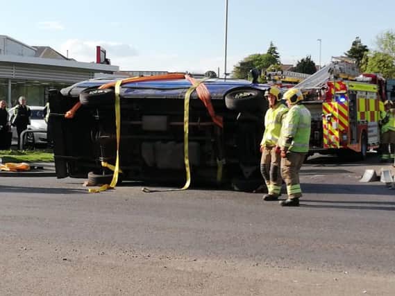 An overturned van outside of Wollaston Motors is causing major delays.