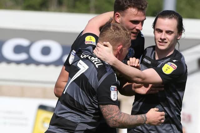 Harry Smith (centre) celebrates his goal for Macclesfield against the Cobblers last month (Picture: Pete Norton)