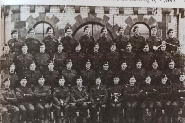 A photo of the S Troop heavy Weapons division of the No 47. Ernie is the furthest left on the second row from the back.
