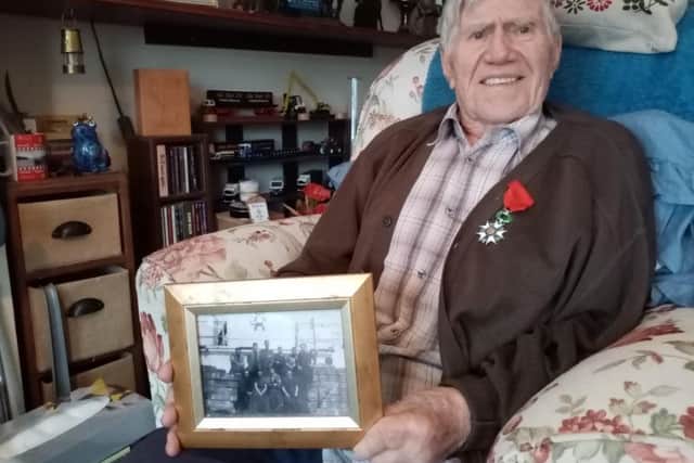 Mark Cudby with his Legion d'Honneur and his framed photo of the 574 crew.