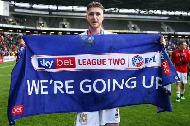 Ryan Watson celebrated promotion with Milton Keynes Dons last month