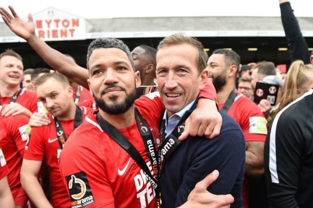 Justin Edinburgh celebrates with Jobi McAnuff after Leyton Orient clinched the National League title in April