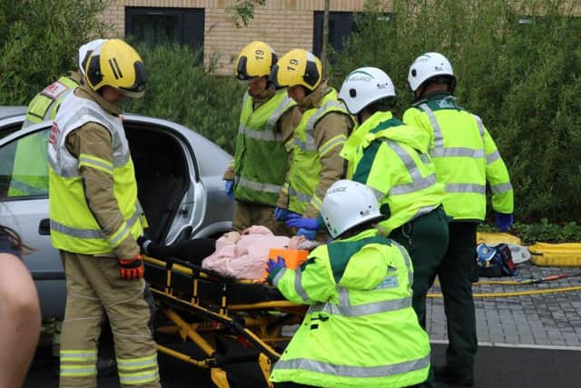 Northamptonshire Fire and Rescue Service pictured assisting the staged incident at the university where the back-seat 'passenger', played by an actor, was stretchered into the back of an EMAS ambulance.