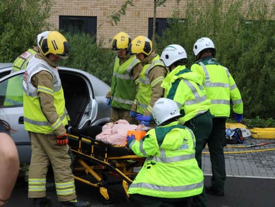 Northamptonshire Fire and Rescue Service pictured assisting the staged incident at the university where the back-seat 'passenger', played by an actor, was stretchered into the back of an EMAS ambulance.
