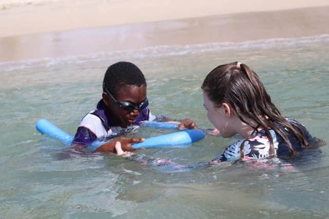 Millie reassures one of the children in the water. Photo: Millie Dorgan