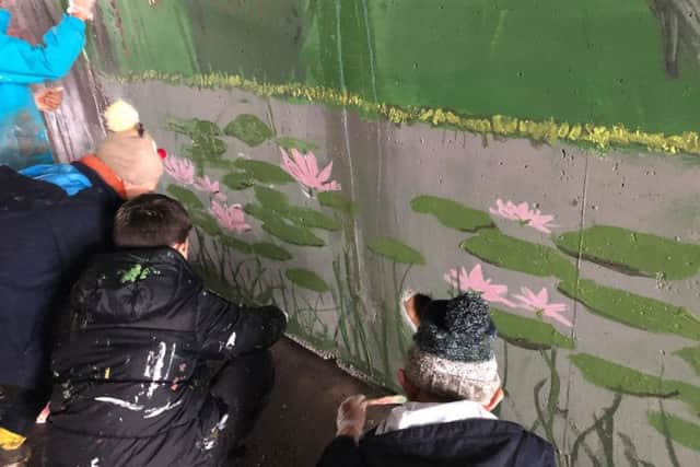 Busy painting the mural. Photo: Nicola Fountain