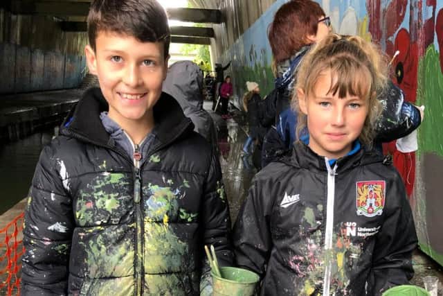Two of the pupils covered in paint. Photo: Nicola Fountain