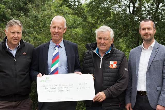 Wooden Spoon presents the 5,000 cheque to Fernie Fields Sports and Social Club