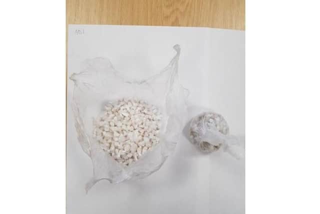 Police found the package held 18 grams of cocaine and 9.36 grams of heroin.