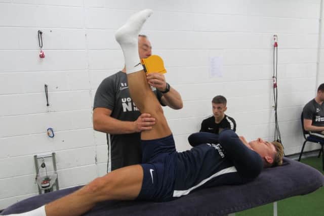 Sam Hoskins stretches out during the morning fitness tests