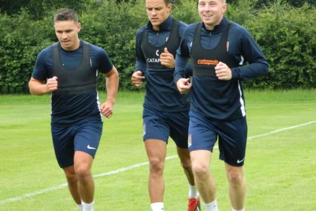 Nicky Adams running alongside Billy Waters and Shaun McWilliams