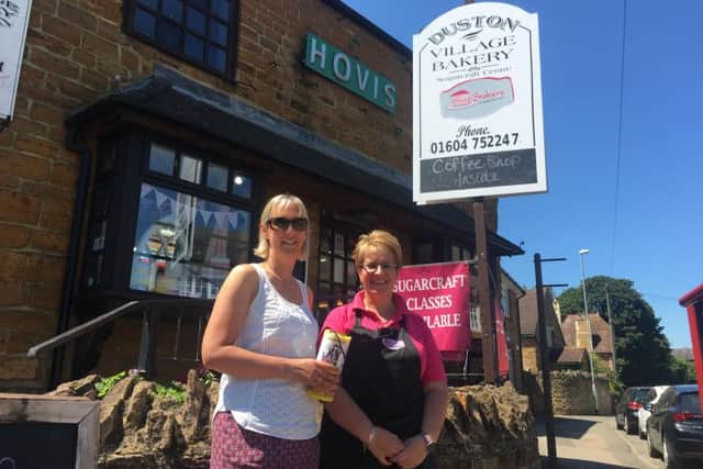 Sisters-in-law Lucy (left) and Jenni Smith with a replacement Thomas' Fund collection tin outside Duston Village Bakery after the break-in