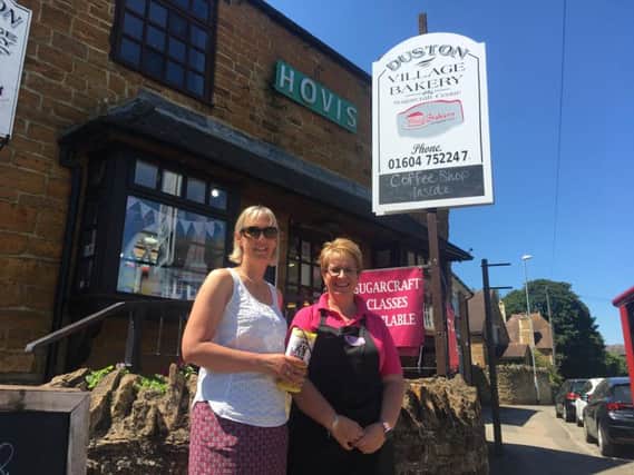 Sisters-in-law Lucy (left) and Jenni Smith with a replacement Thomas' Fund collection tin outside Duston Village Bakery after the break-in