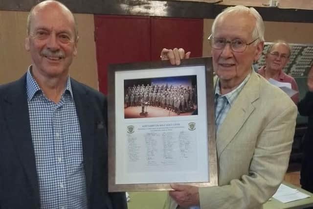 Mike Davis pictured (right) receiving the photo from the Northampton Male Voice Choir Chairman, John Waller.