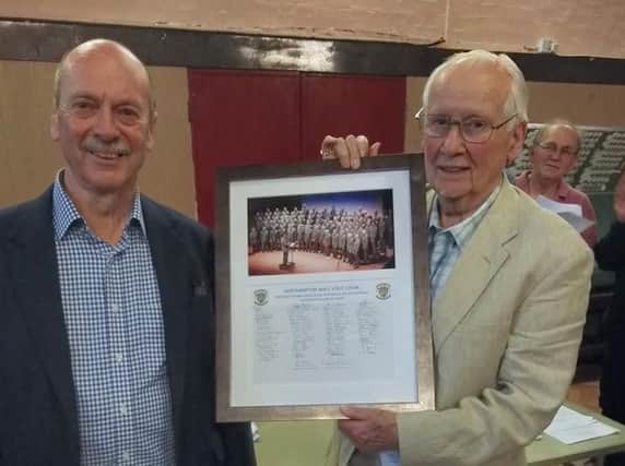 Mike Davis pictured (right) receiving the photo from the Northampton Male Voice Choir Chairman, John Waller.