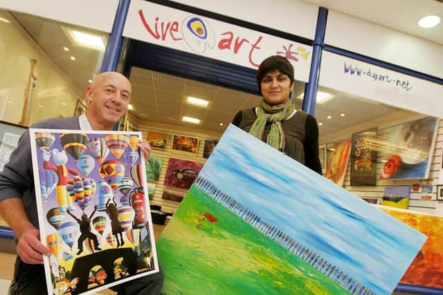 Artists Mark Pacan and Daxa Parma with their work at their Live Art shop in Peacock Place, c.2010. Photo by James Corbett.