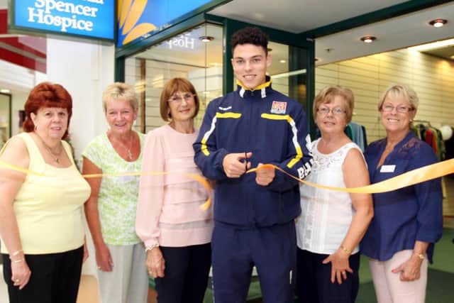 Special guest and Cobblers player Lewis Hornby snips the ribbon for Cynthia Spencer Hospice charity shop. L-R Sandy Cosford, Maureen Wreford, Yvonne Walding, Lewis Hornby, Judy Fitch and Linda Mace.