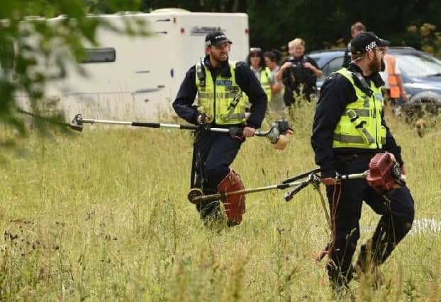Police at the scene. PHOTO BY ANDREW CARPENTER