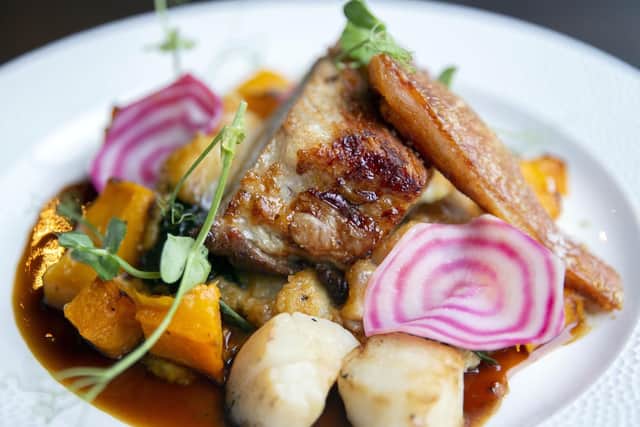 Rotisserie sticky glazed pork belly (outdoor-reared heritage breed) with smoky creamed corn, golden beetroot, cavolo nero mashed potato, red-wine jus and crispy crackling and scallops.