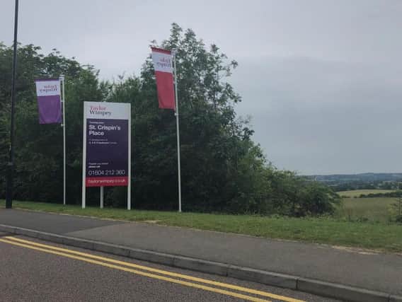 A sign for the "St Crispin's Place" development has gone up in Duston.