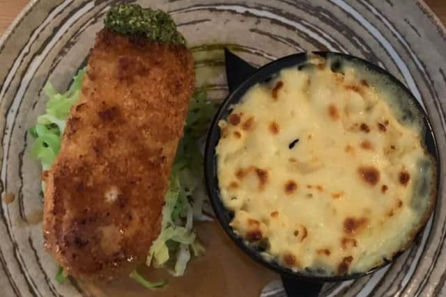Cornfed chicken kiev stuffed with wild garlic butter, wilted greens, truffled mac and cheese, chicken sauce