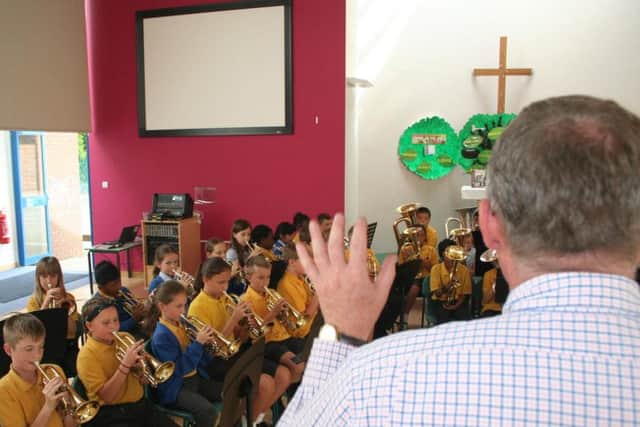 Lead music teacher James Bonson sets the pace.