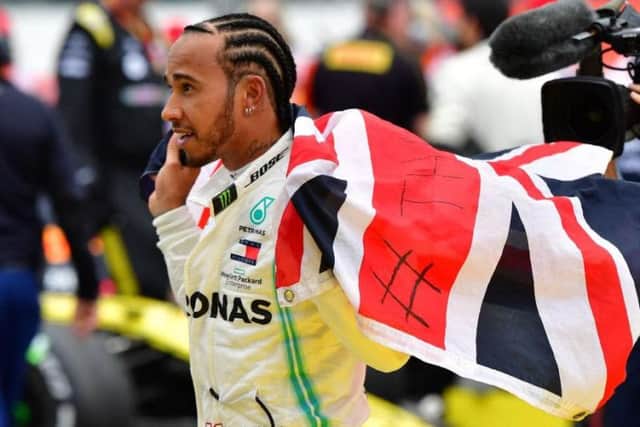 Lewis Hamilton flies the flag