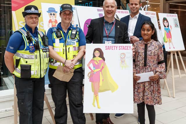 Mahima Begun with her winning design, Safety Stacey, with police officers and PFCC Stephen Mold at the Grosvenor Centre. Photo: Photocall-Events