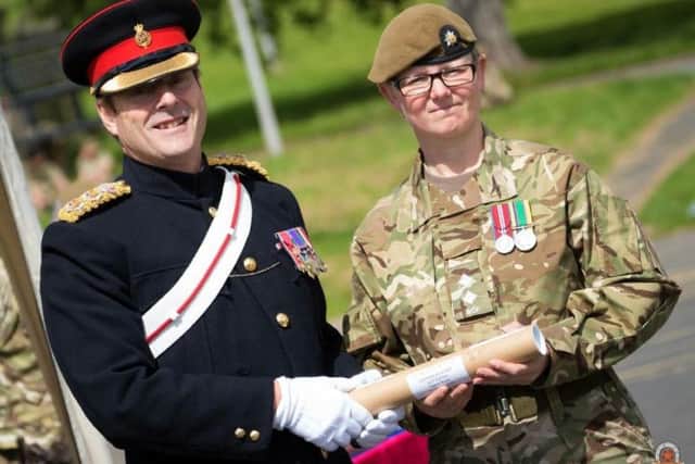 Maria being presented with her commission.