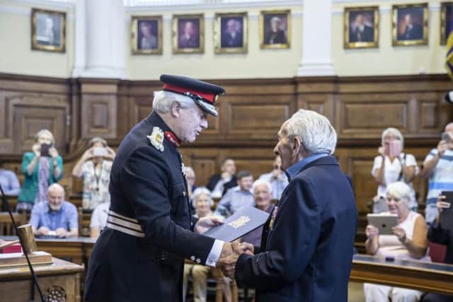 Albert's family and friends stood to applaud the 95-year-old as he received his medal.