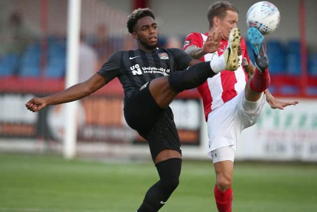 Reece Hall-Johnson with Brackley's Carl Barker. Picture: Pete Norton