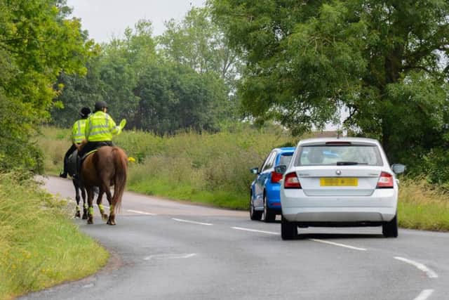 Northamptonshire Police volunteers on horseback riders wave past considerate drivers during the Operation Close Pass test